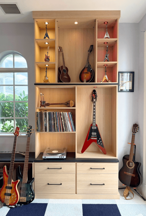 Custom guitar display cabinet with LED lighting for a teen room by California Closets in South Palm Beach, Florida, featuring luxury guitar storage and custom music room organization near Boca Raton.