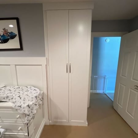 Virginia Beach - Custom closets - Tall, narrow storage cabinet in a bedroom beside a dresser.