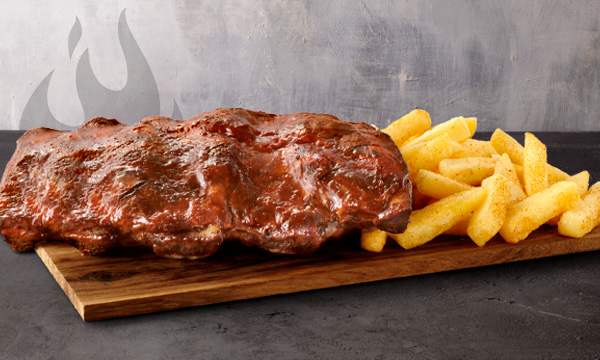 Single Beef rib rack with chips on a wooden board placed on a grey surface with a purple background.
