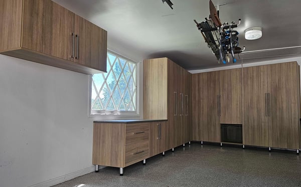 Garage storage with A counter top, tall cabinets, and high up cabinets