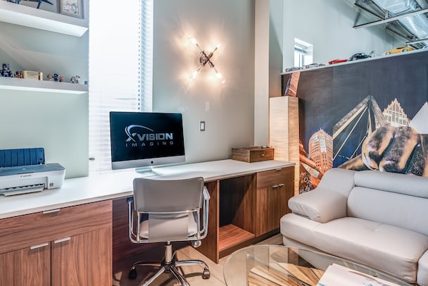 Custom, commercial office with cherry wood and grey, matte countertop.