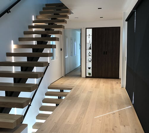 Entryway closet storage with light glass shelves in dark wood grain finish by California Closets Orange County
