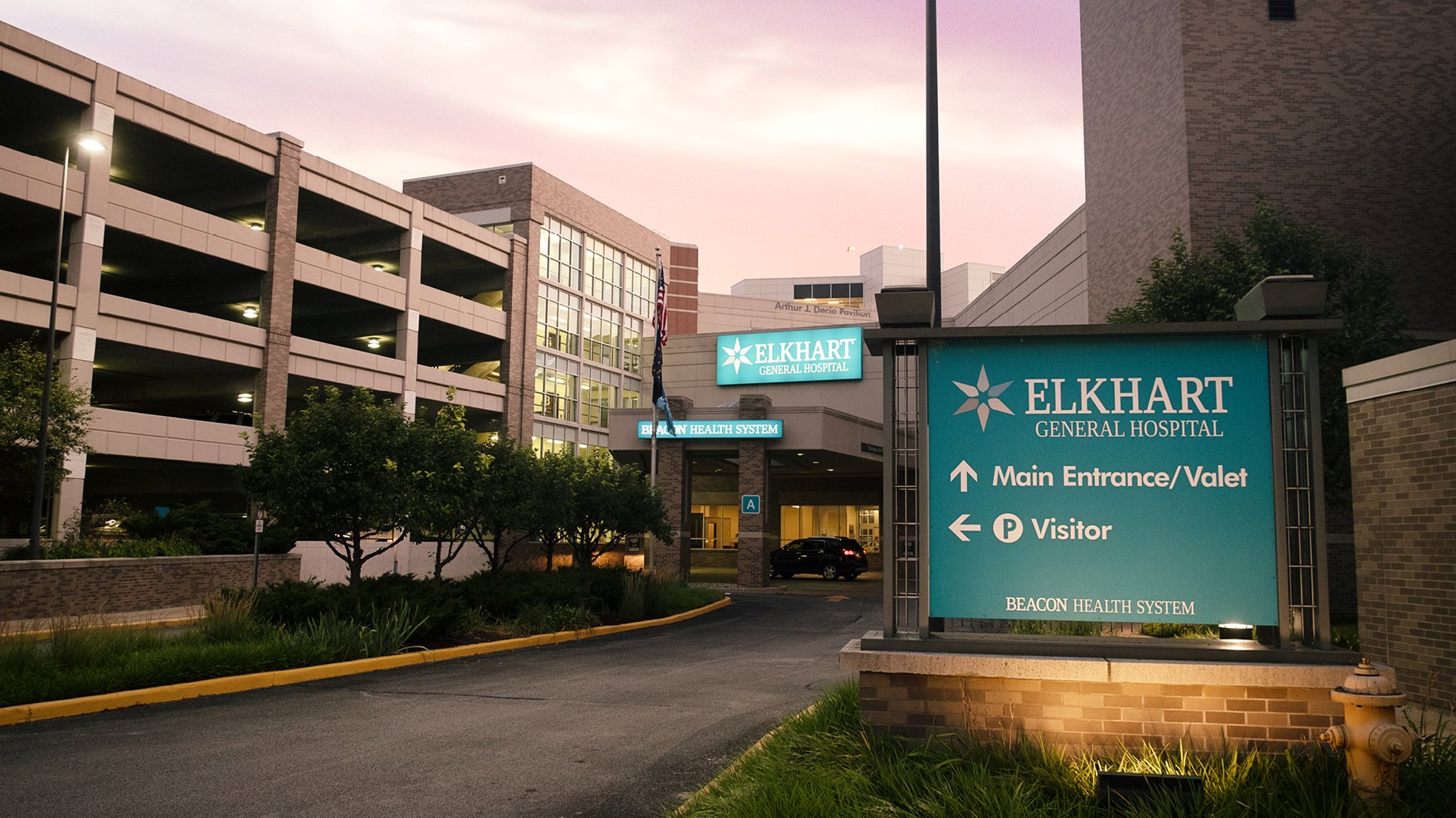 The entrance to Elkhart General Hospital has a teal sign that indicates the parking lot and entrance.