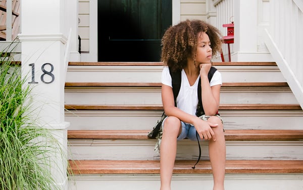 Child on steps of house covered by home insurance