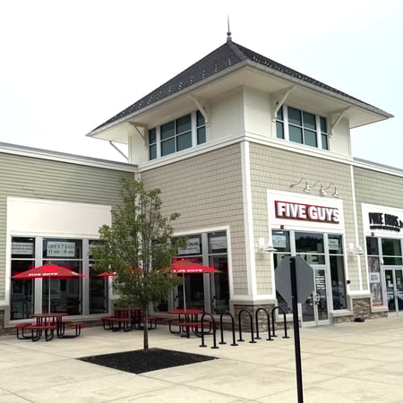Exterior photograph of the Five Guys restaurant at 158 Great Road in Bedford, Massachusetts.