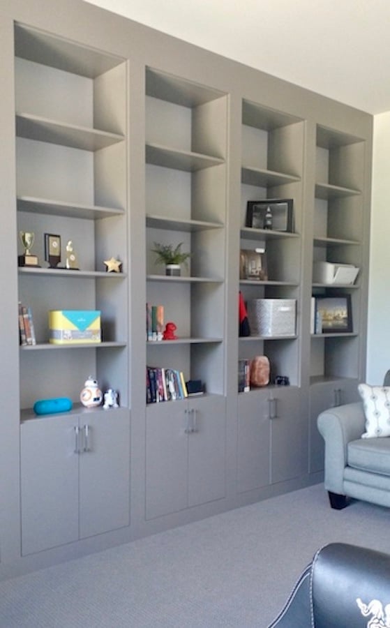 Grey woodgrain used in custom, built-in library shelving.