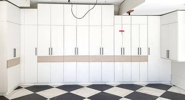 High end garage storage design with built in cabinets for organization by California Closets Orange County