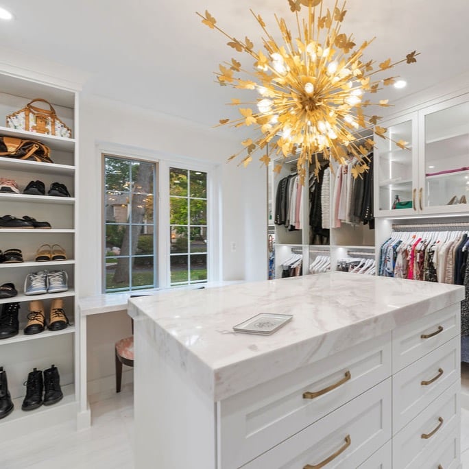 Custom walk-in closet with pink marble countertops by California Closets Greater Detroit, Michigan.