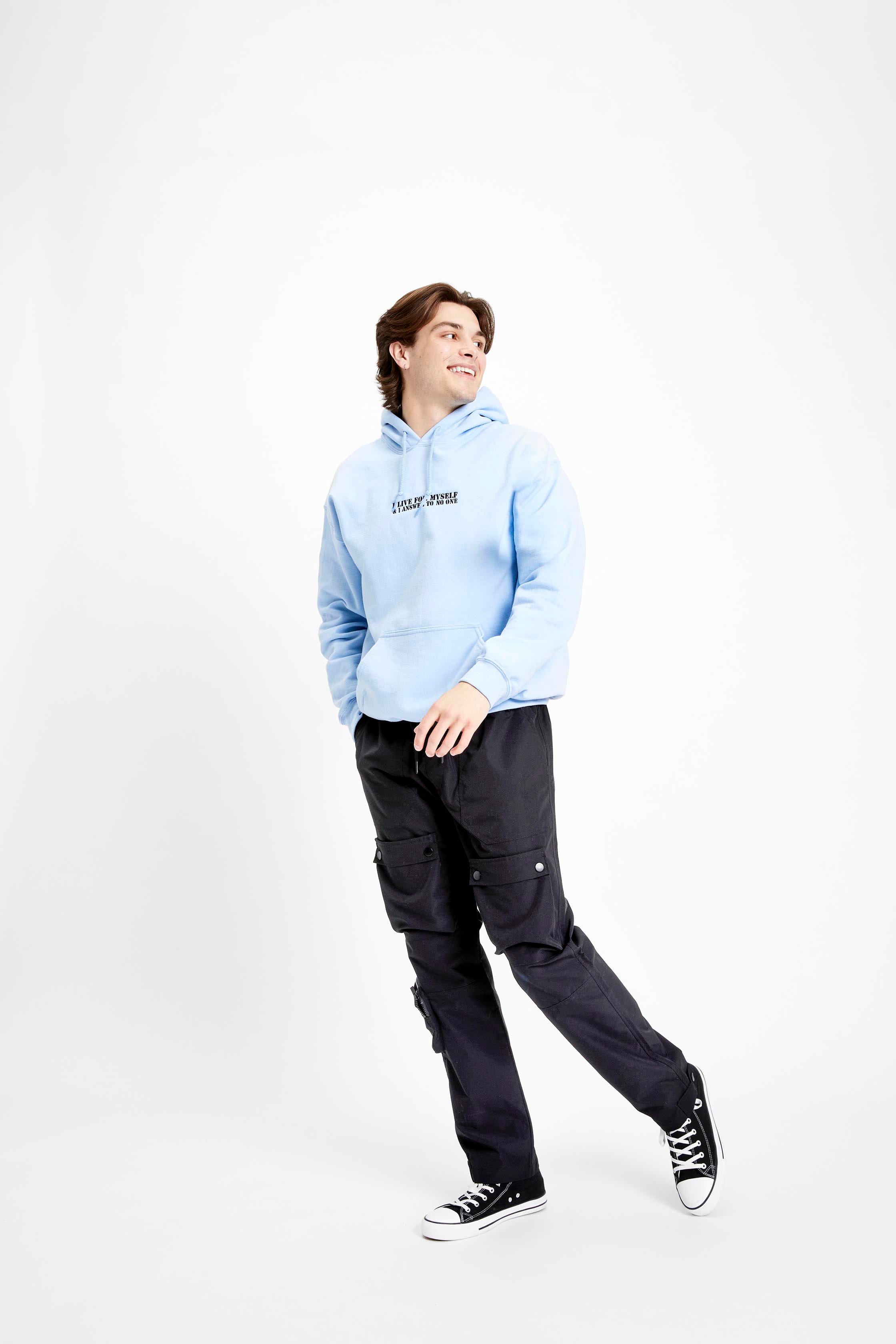 A male model wearing black cargo pants and a baby blue hoodie from rue21
