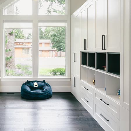 Custom closet design with shelves, drawers, and cabinets for workspace area by California Closets