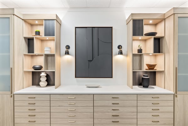 open bookshelves and drawers in light finish with white countertops and frosted glass doors