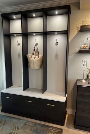 Entryway in dark finish with white accents, hooks and lighting