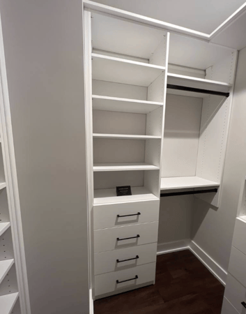 Classic white shelving and drawers with black accessories.