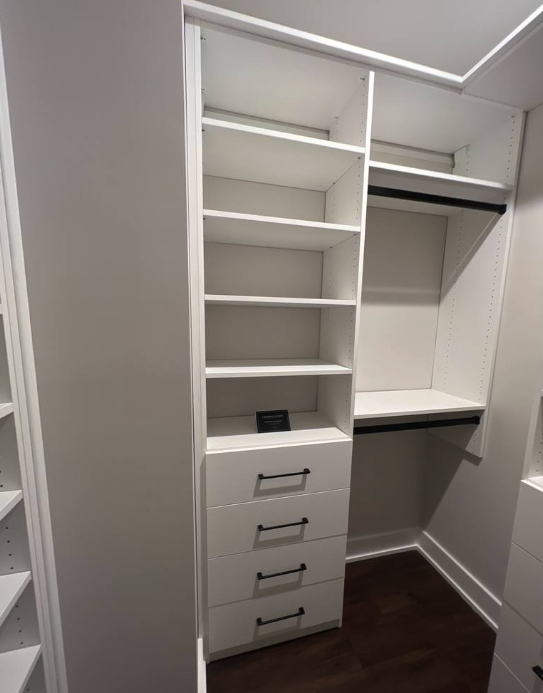 Classic white shelving and drawers with black accessories.