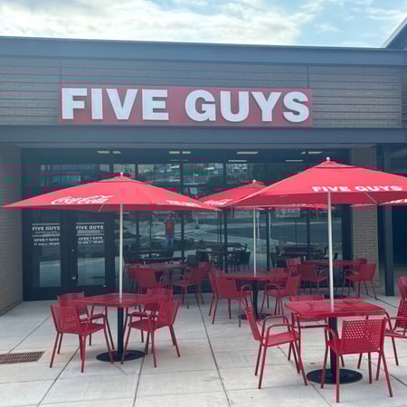Exterior photograph of the Five Guys restaurant at 1606 Commonwealth Avenue in Charlotte, North Carolina.