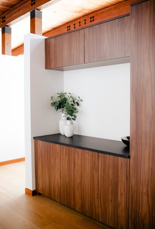wood-toned entryway wardrobe with dark counter space by California Closets Vancouver, British Columbia.