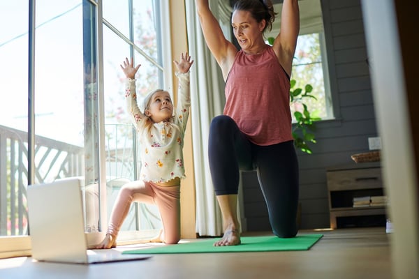 Mother and child doing yoga together at home