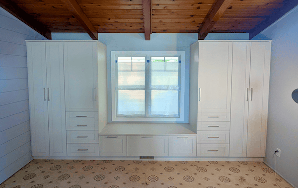 Guest bedroom wardrobe and closet storage with white cabinets