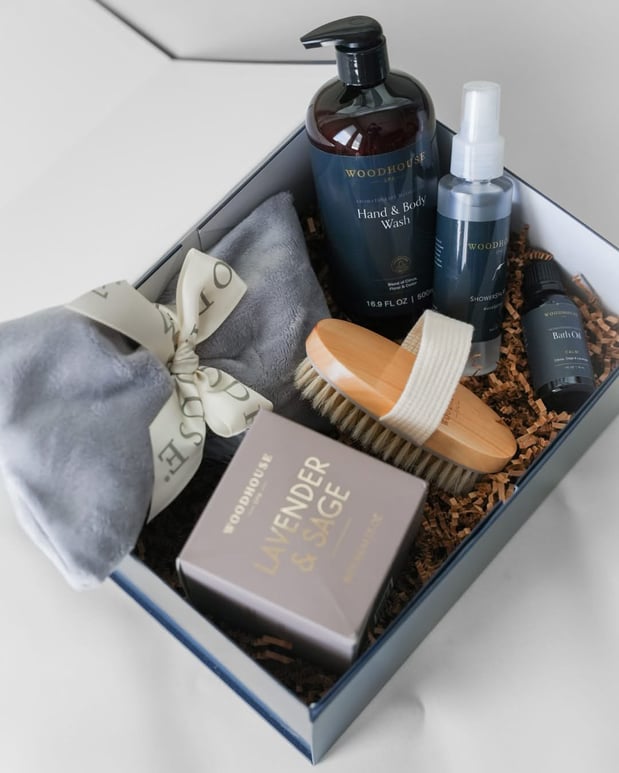 Spa gift box with skincare items, bath bomb, and body brush.