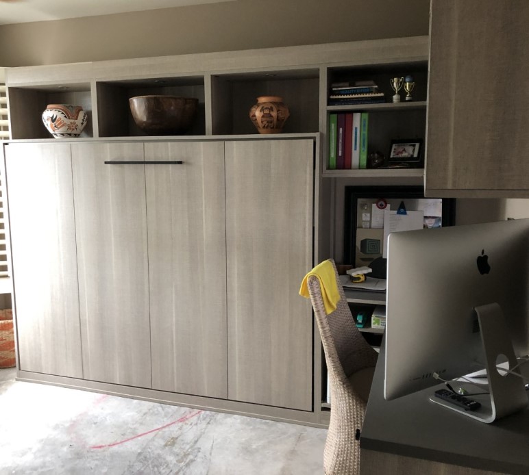 Light woodgrain horizontal wall bed, shelving and desk