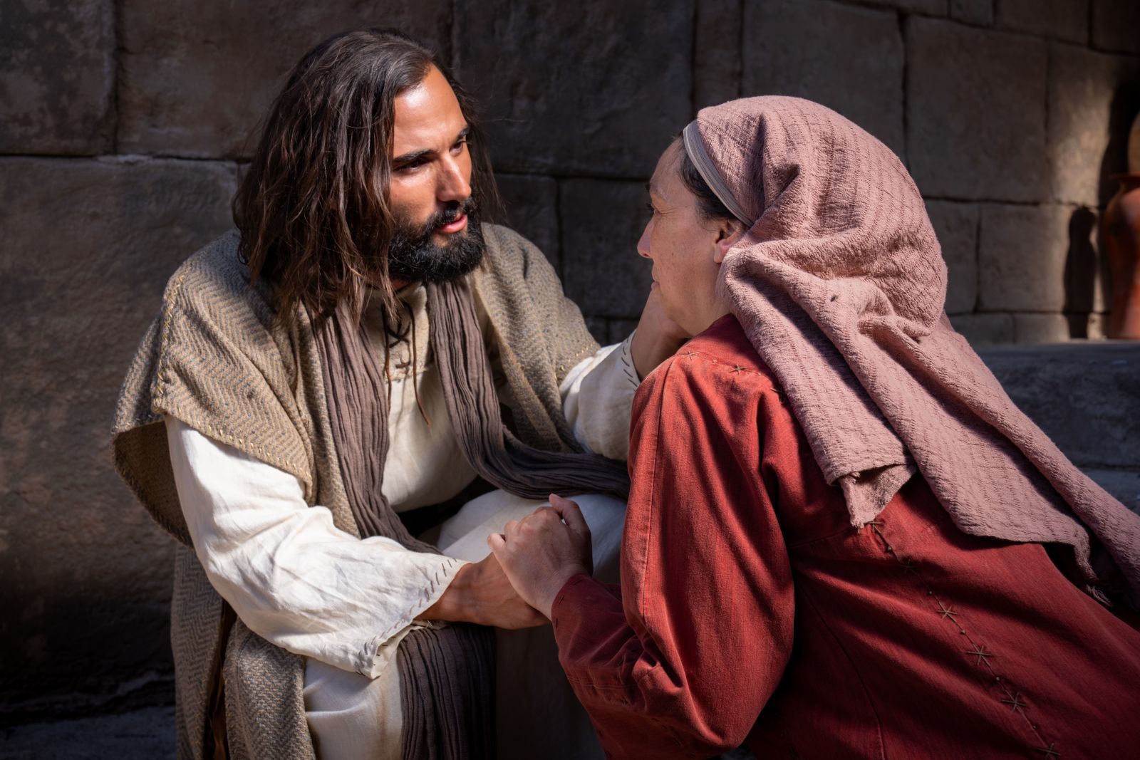 Jesus  reaches out to a woman.