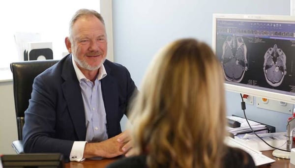 Neurosurgeon in consultation with a patient.