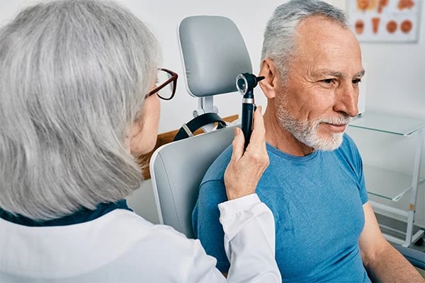 Man gets hearing exam from an AudioNova audiologist. TENTATIVE IMAGE UNTIL WE GET A FINAL ONE.