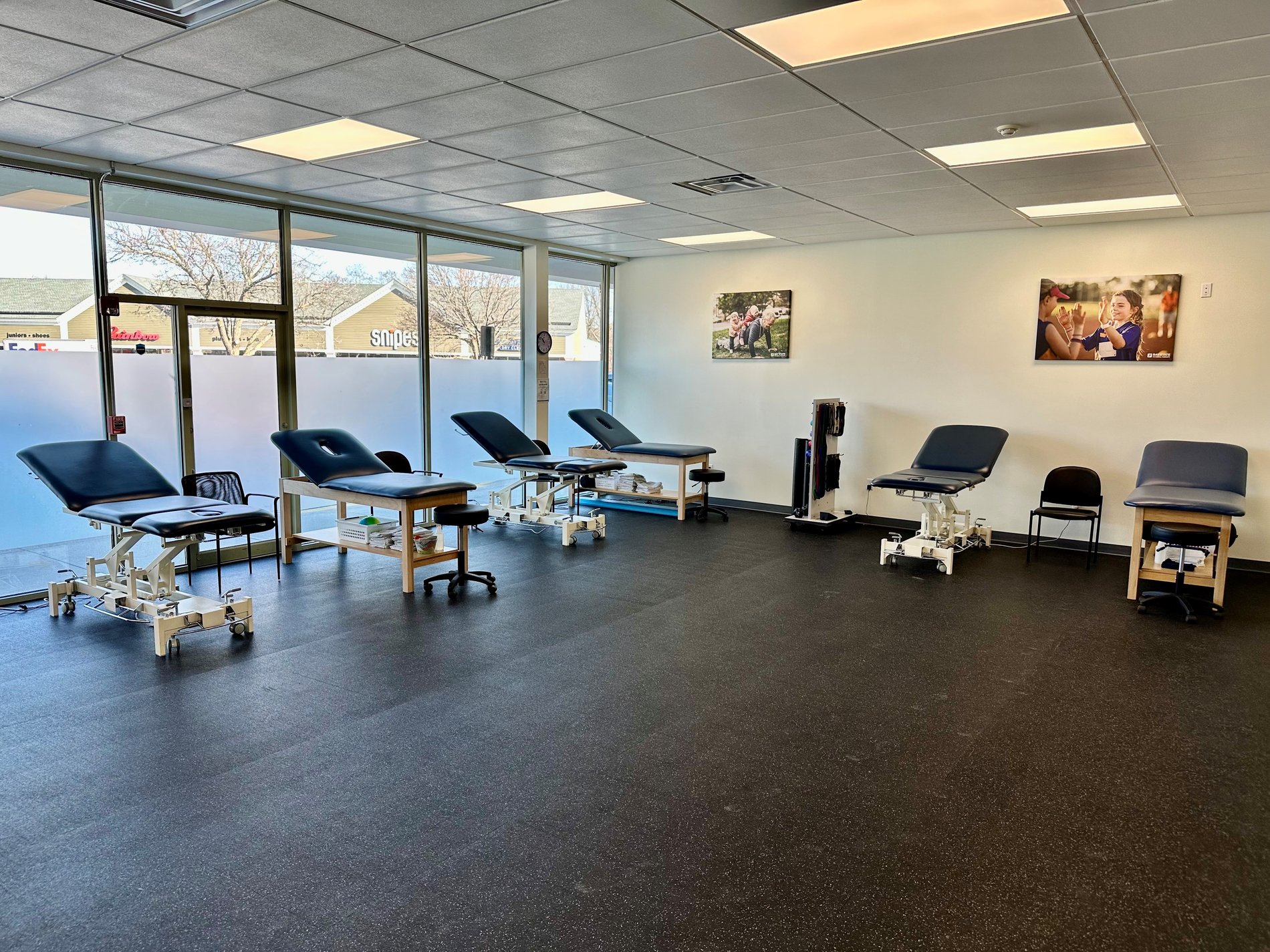 RI-NorthProvidence Bay State Physical Therapy patient care area with PT Tables.