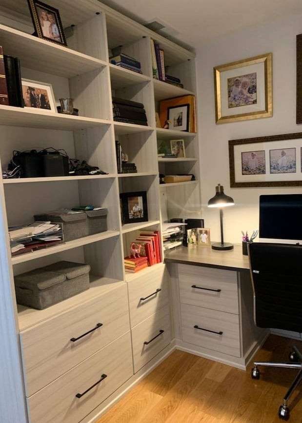 A built-in shelving unit with integrated drawers in an office.