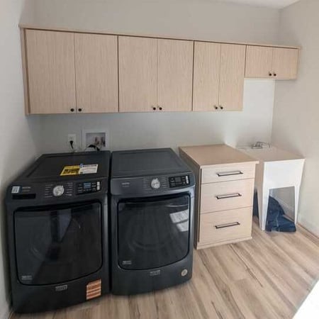 Richmond - Custom closets - laundry room with wall-mounted cabinets, drawer storage, and a folding counter above front-loading washer and dryer