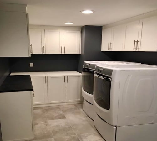 Custom laundry room with washer/dryer, light grey wood cabinets