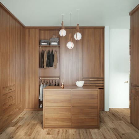 Custom walk in closet with floor to ceiling cabinets, center island and custom shelves by California Closets