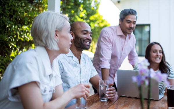 Entertaining guests in the backyard sitting at table