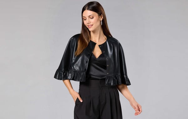 Woman is wearing a black outfit from Cache.