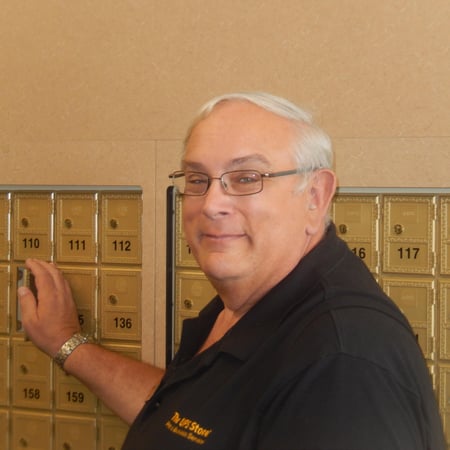 franchisee standing in front of mailboxes