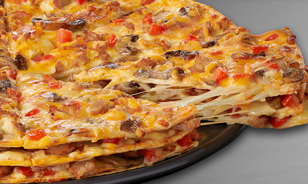 Triple-Decker® Specialty pizza from Debonairs Pizza on a black plate against a grey background.