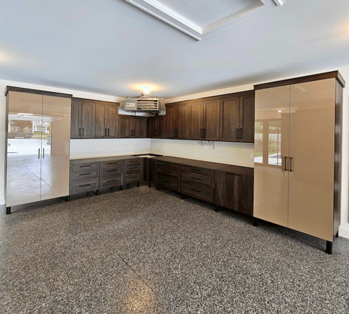 Garage storage with A counter top, tall cabinets, and high up cabinets