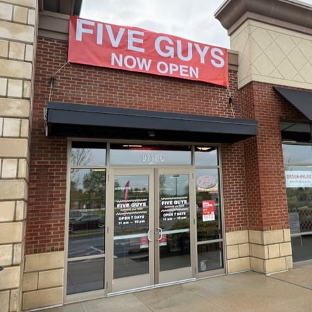An exterior photograph of the Five Guys restaurant at 9711 Sawmill Parkway in Powell, Ohio.