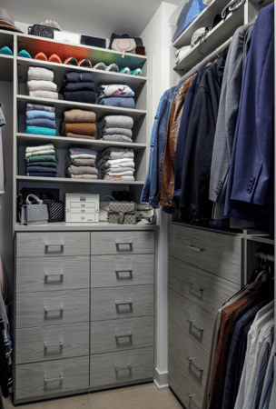 gray his side walk-in closet with shelving for folded clothing, drawers, and hanging for suit jackets Brooklyn New York