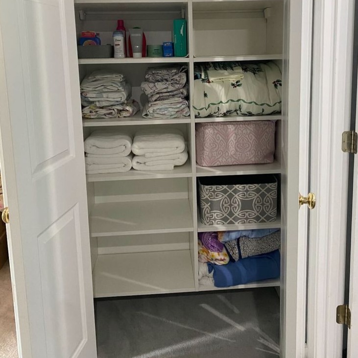 Richmond - Custom closets - linen closet with neatly folded towels and organized shelving