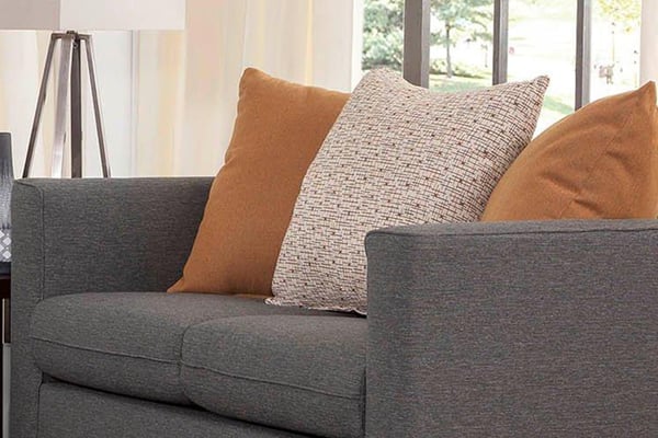 grey couch with pillows