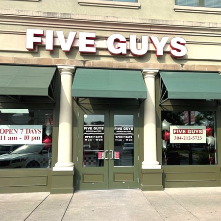 Exterior photograph of the Five Guys restaurant at 1000 Suncrest Town Center Drive in Morgantown, West Virginia.