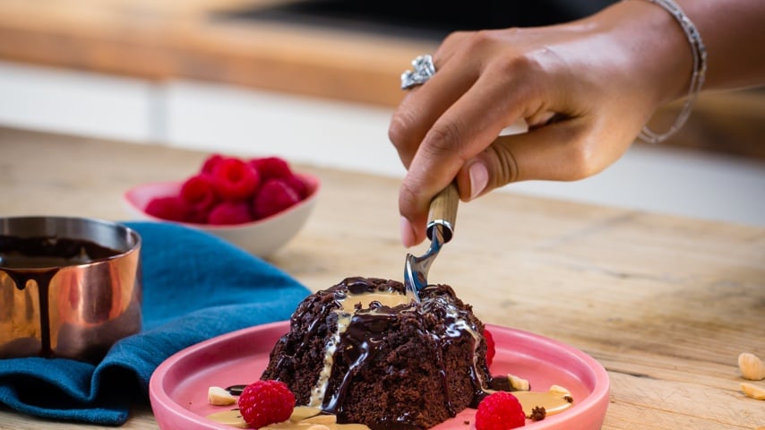 Person cutting Baileys Volcano cake with a spoon