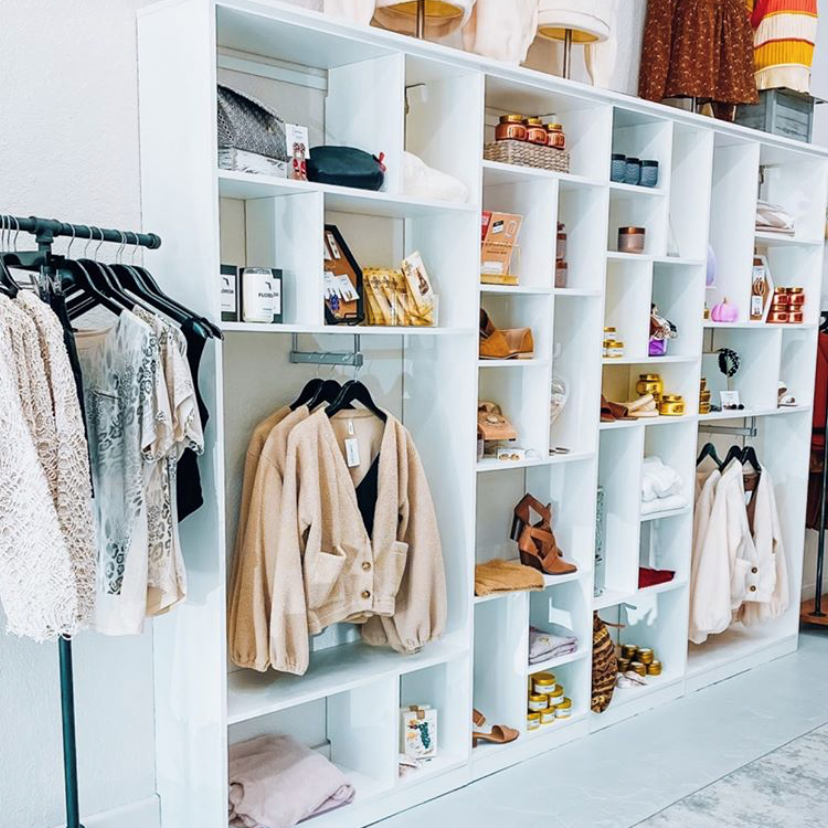 A retail-inspired space in a soft dove finish with front-to-back hanging for optimal display.