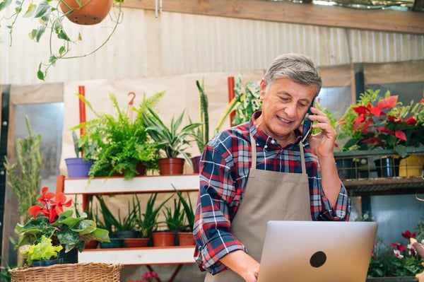 Business Flower shop owner on VOIP phone and using Internet Service