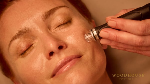Woman receiving a Deluxe Hydrafacial at Woodhouse Peachtree City