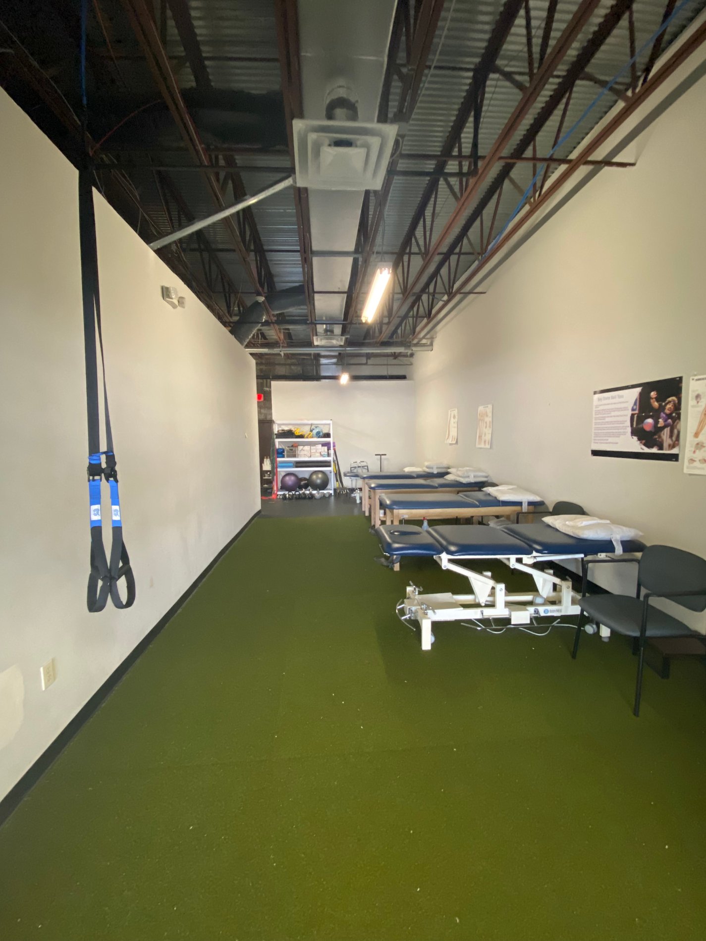 Inside Bay State Physical Therapy Chelmsford, MA Parkhurst St. showing PT patient tables in the background.