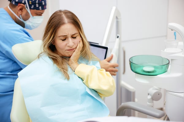 Patient in dental chair with pain
