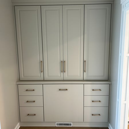 Custom built in storage with drawers and cabinets.