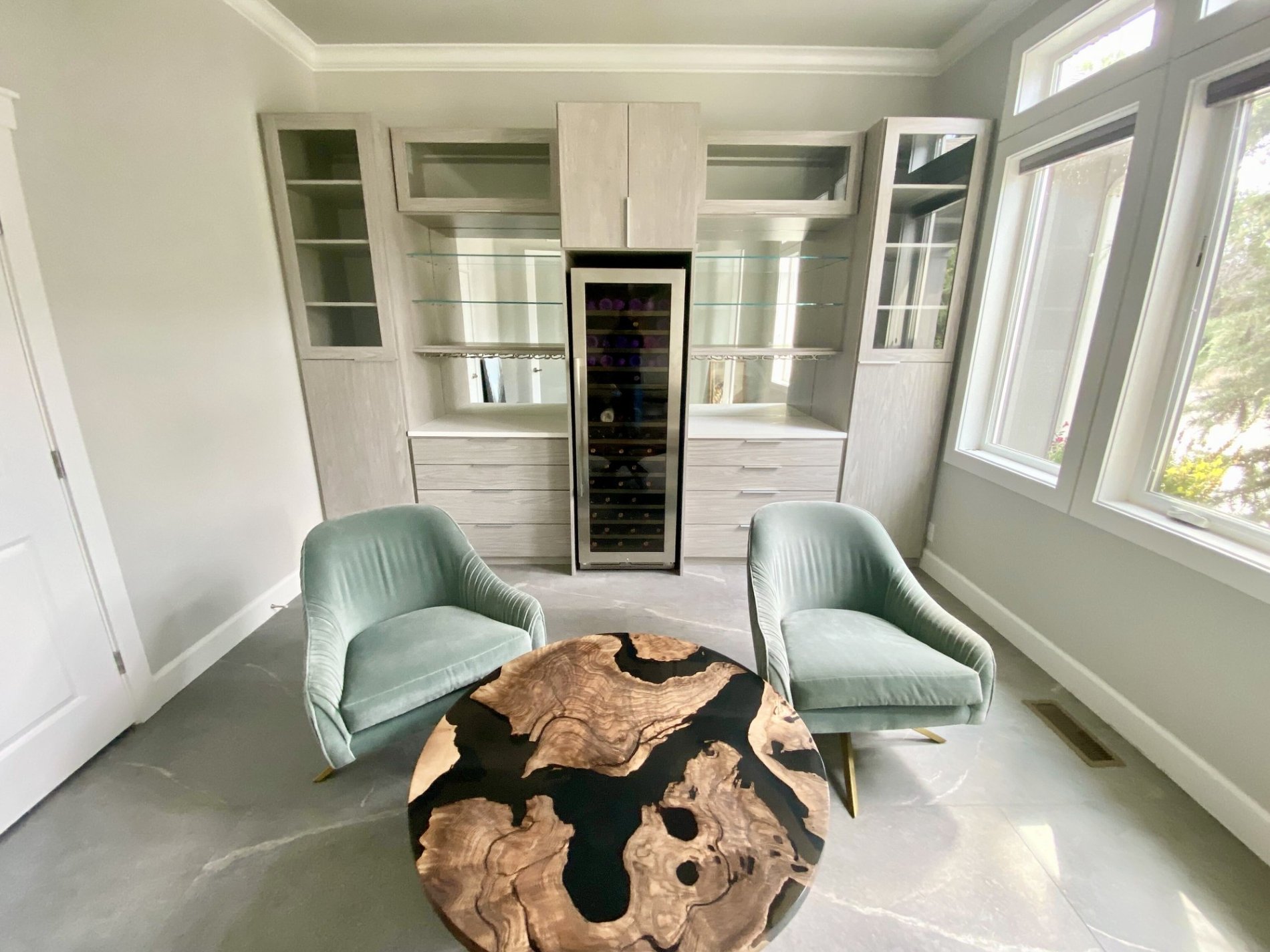 Bar with built in wine refrigerator and glass shelves